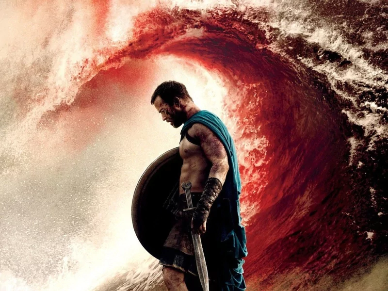 Warrior in armor stands with sword and shield against a massive, swirling red wave in the movie 300: Rise of an Empire.