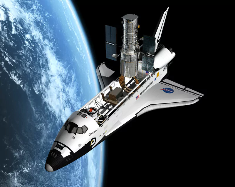 Space Shuttle Discovery orbiting Earth with the Hubble Space Telescope deployed from its cargo bay.