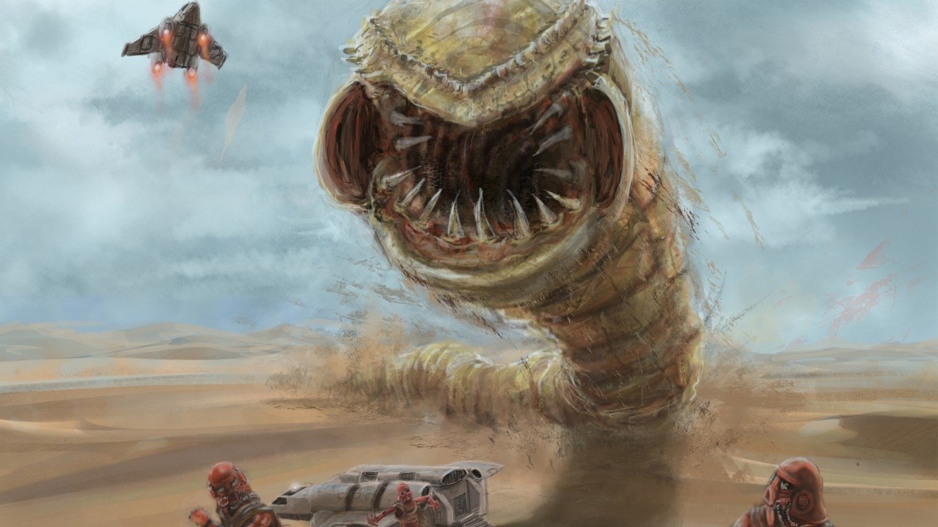 A massive sci-fi worm monster emerges from the dune as armed figures and a flying craft confront it in a desert landscape.