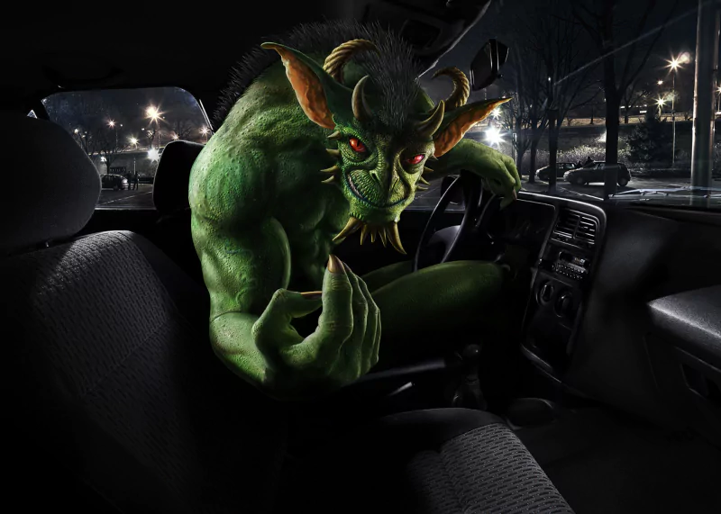 A green, horned fantasy creature with red eyes and claws leans into a parked car at night — a dark fantasy monster filling the vehicle's interior.