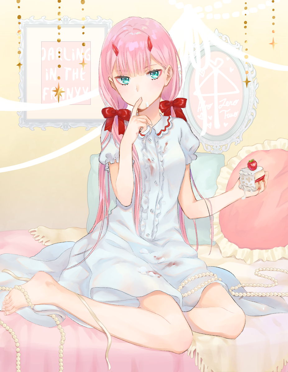 Zero Two from Darling in the FranXX sits barefoot on a bed, wearing a white dress with red ribbons, holding a small cake, her pink hair and blue eyes striking against the soft pastel background.