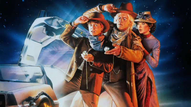 Promotional image from the movie Back To The Future Part III, featuring three characters in Western attire standing by a futuristic car in a starry night setting.