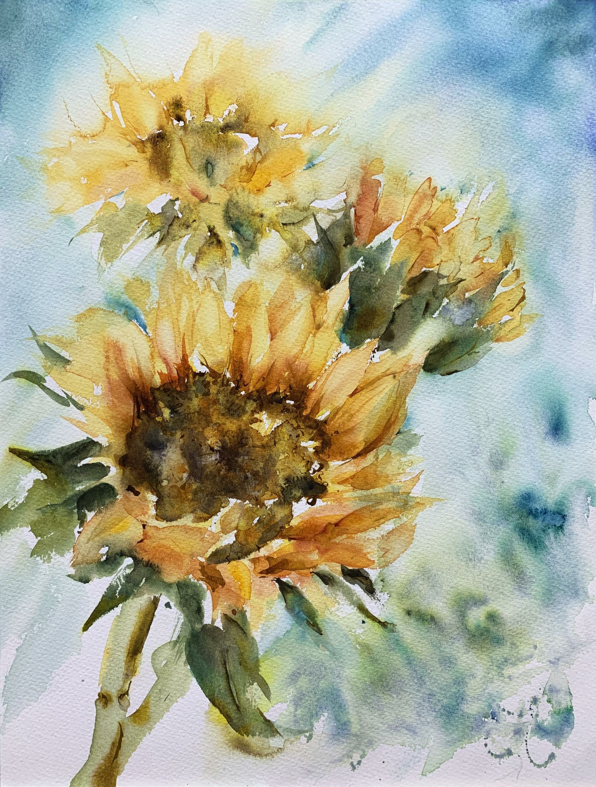 Watercolor nature scene of three sunflowers rendered with loose, luminous brushstrokes in yellow, green and blue, showing textured seed centers and an airy, soft-focus background.
