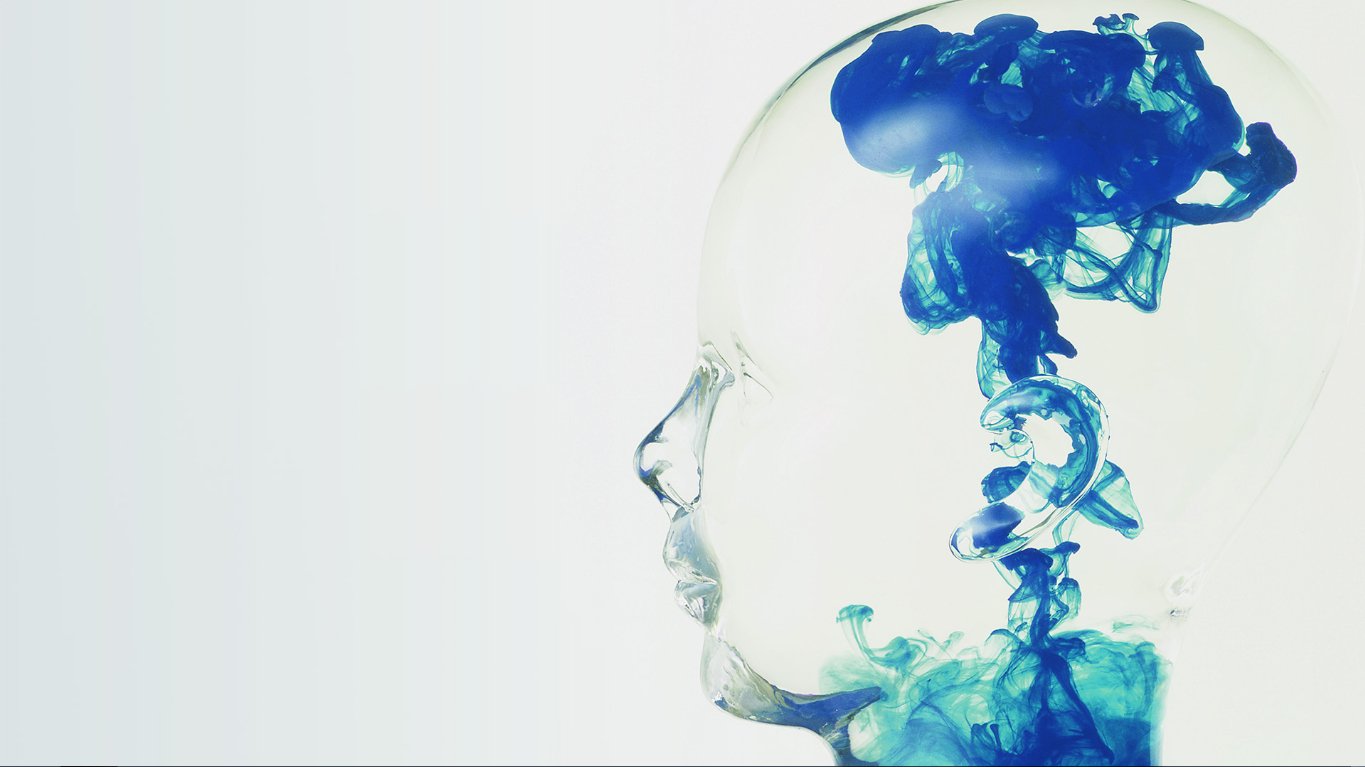 Abstract image of a translucent human head with blue diffusion-like ink swirling inside, blending art and scientific visualization.