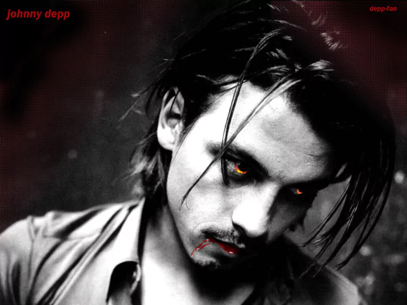 A black and white portrait of Johnny Depp, featuring intense eyes and a contemplative expression, with a touch of red that adds a dramatic flair to the image.