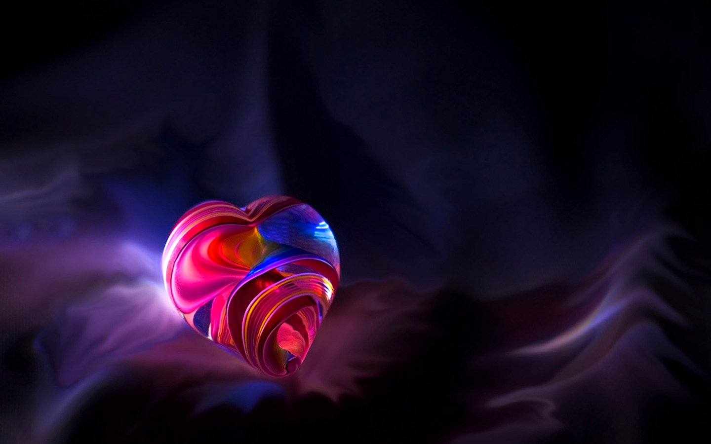 A vibrant, swirling heart sits against a dark, ethereal background, showcasing an artistic blend of colors in this captivating digital art piece.