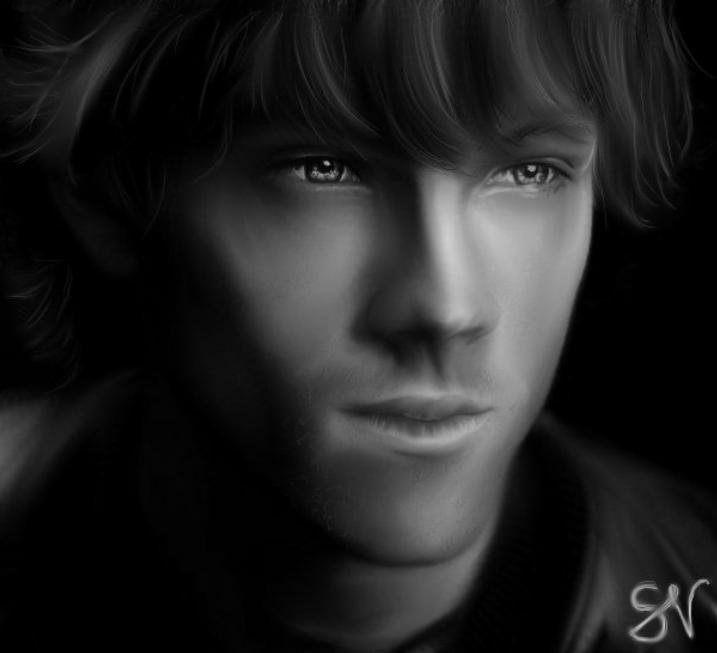 Black and white close-up portrait of celebrity Jared Padalecki with soft lighting highlighting his facial features and expressive eyes.