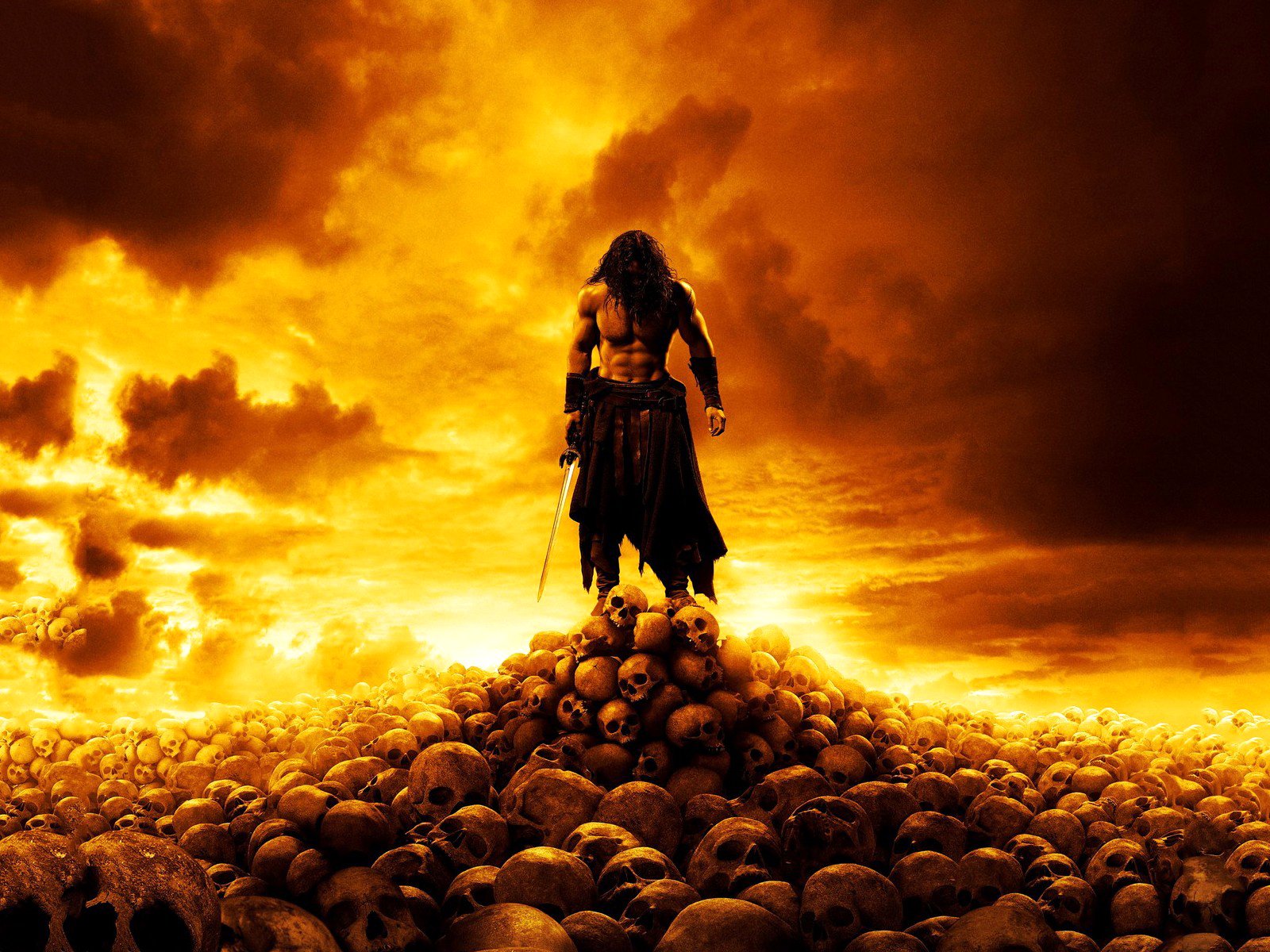 A powerful figure stands atop a mound of skulls against a dramatic orange sky, evoking the intense atmosphere of the Conan video game.