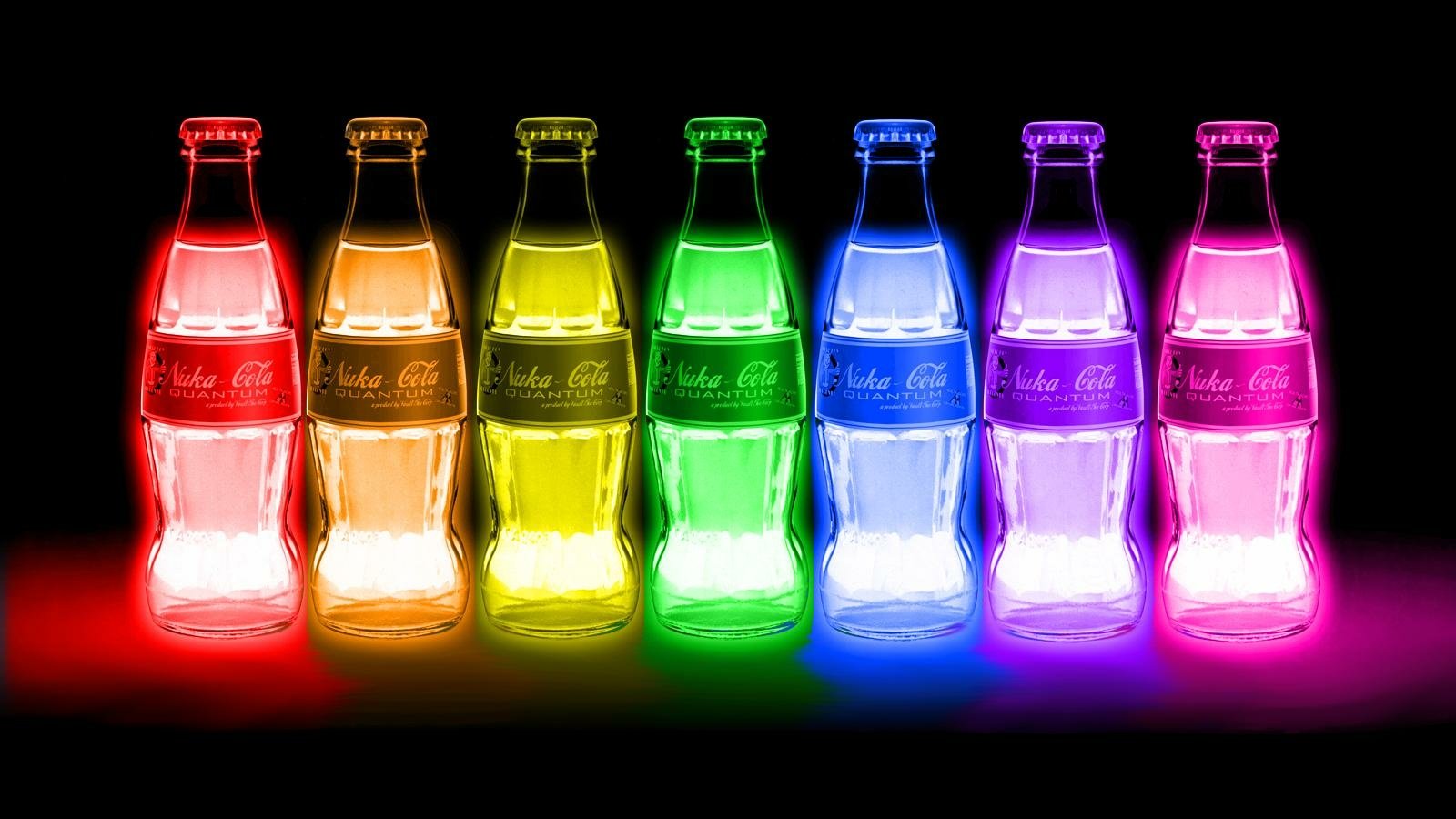 Glowing bottles of Nuka Cola Quantum arranged in a rainbow spectrum, referencing the iconic beverage from the Fallout video game series.