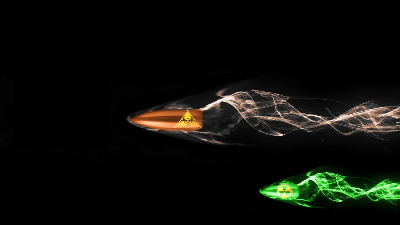 Two man-made bullets captured in motion against a black background, one with orange and the other with green glowing trails.