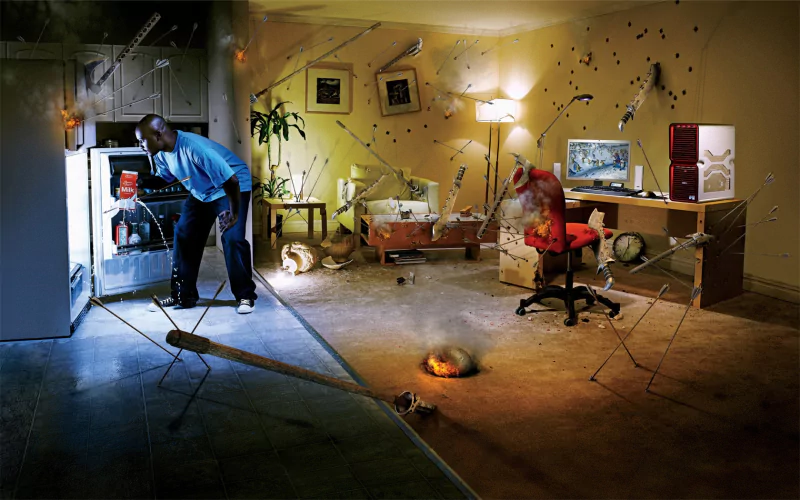A creatively manipulated photograph features a man interacting with an unusual scene, showcasing surreal elements and dynamic visual effects in a domestic setting.