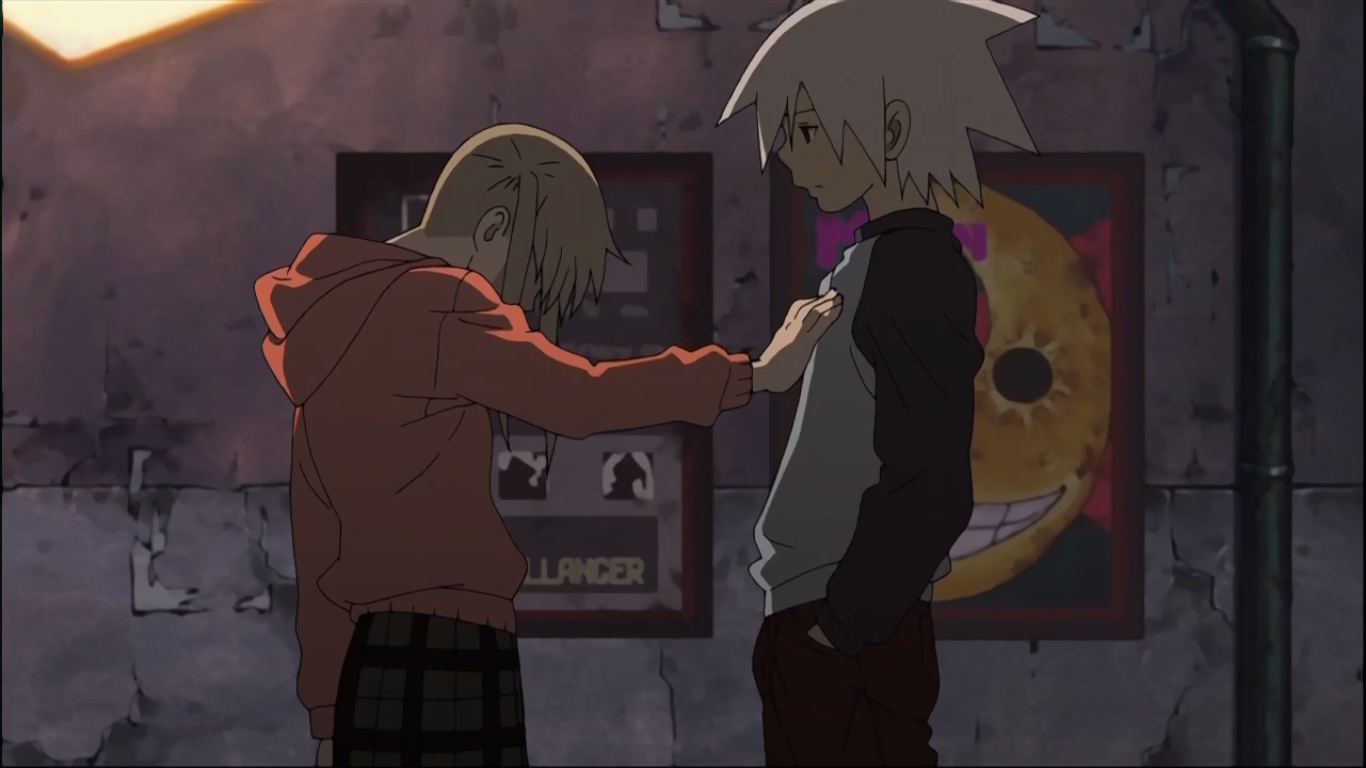 Maka Albarn places a hand on Soul Evans's chest in a dim, graffiti-covered alley; the two from Soul Eater share a quiet, tense moment with posters on the wall behind them.
