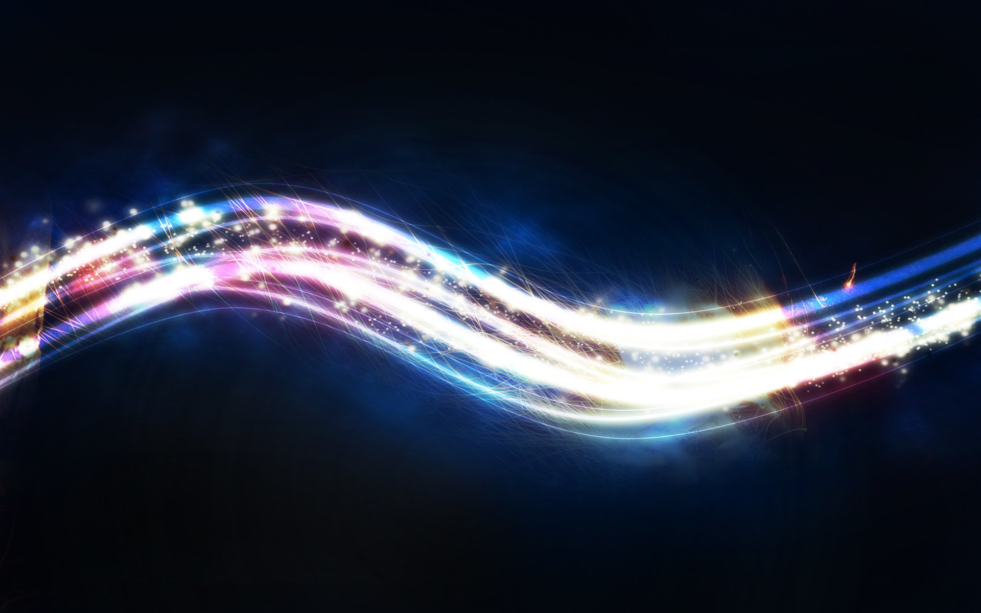 Abstract glowing multicolored ribbons of light and sparkling particles forming a flowing wave on a dark background.