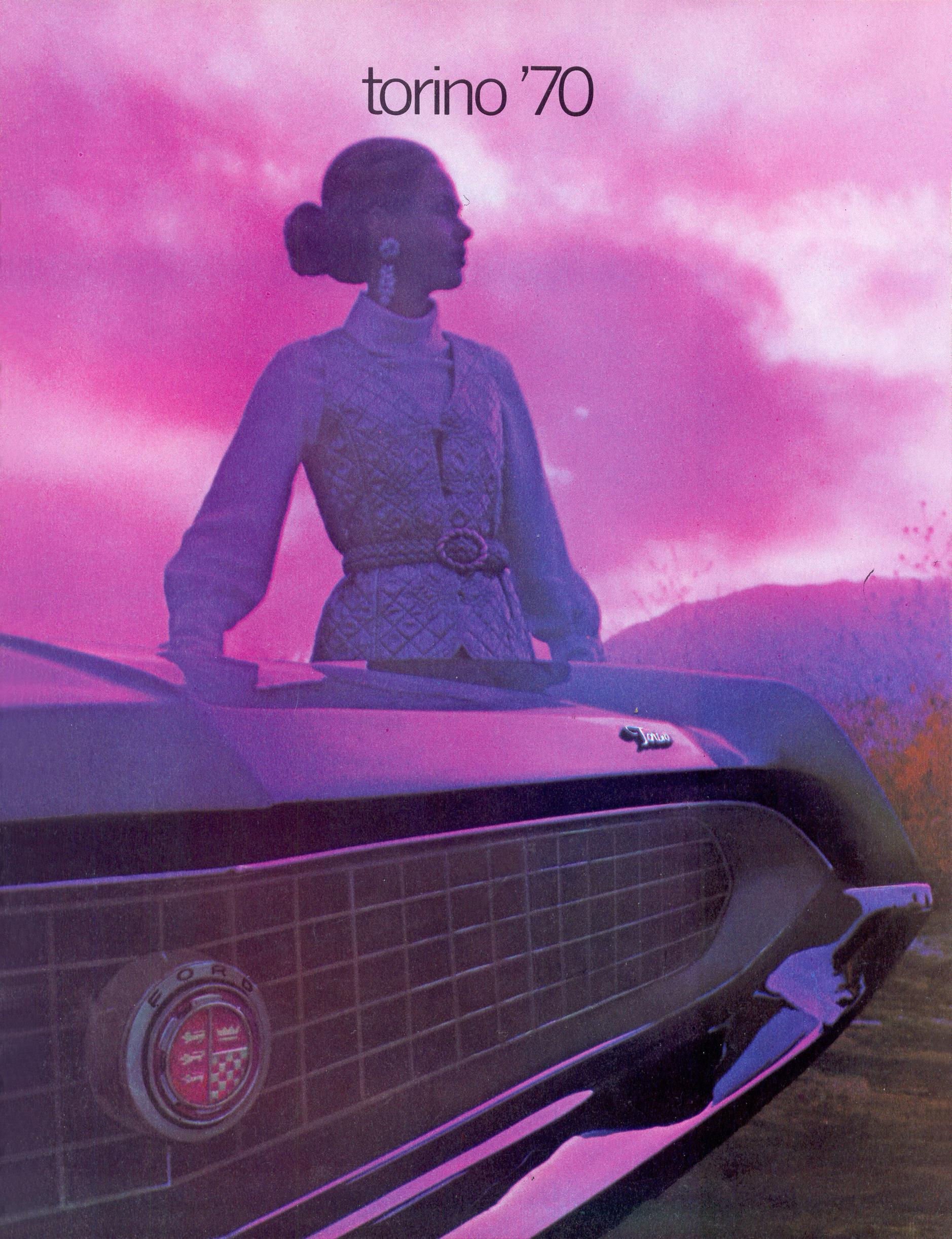 A woman stands beside the front grille of a 1970 Ford Torino against a purple-pink sunset sky, with torino '70 text above.