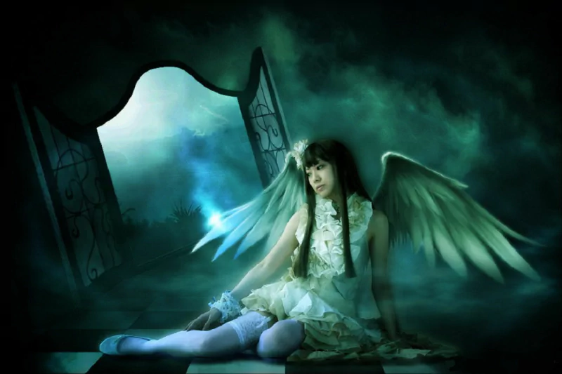 An Asian woman with angelic wings sits in a fog-covered landscape, near a mysterious door leading to a mountain, evoking a sense of sadness and longing.