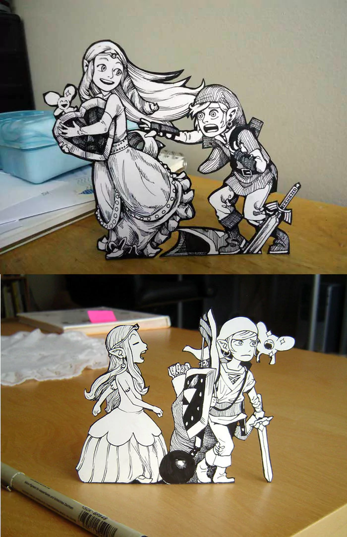 Paper art figures of Princess Zelda and Link from The Legend of Zelda video game, depicted in dynamic, black-and-white illustrated style on a wooden surface.