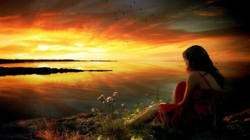 A captivating artistic painting of a woman in a red dress sitting by the water, gazing at a sunset reflecting vibrant orange and yellow hues across a tranquil landscape.