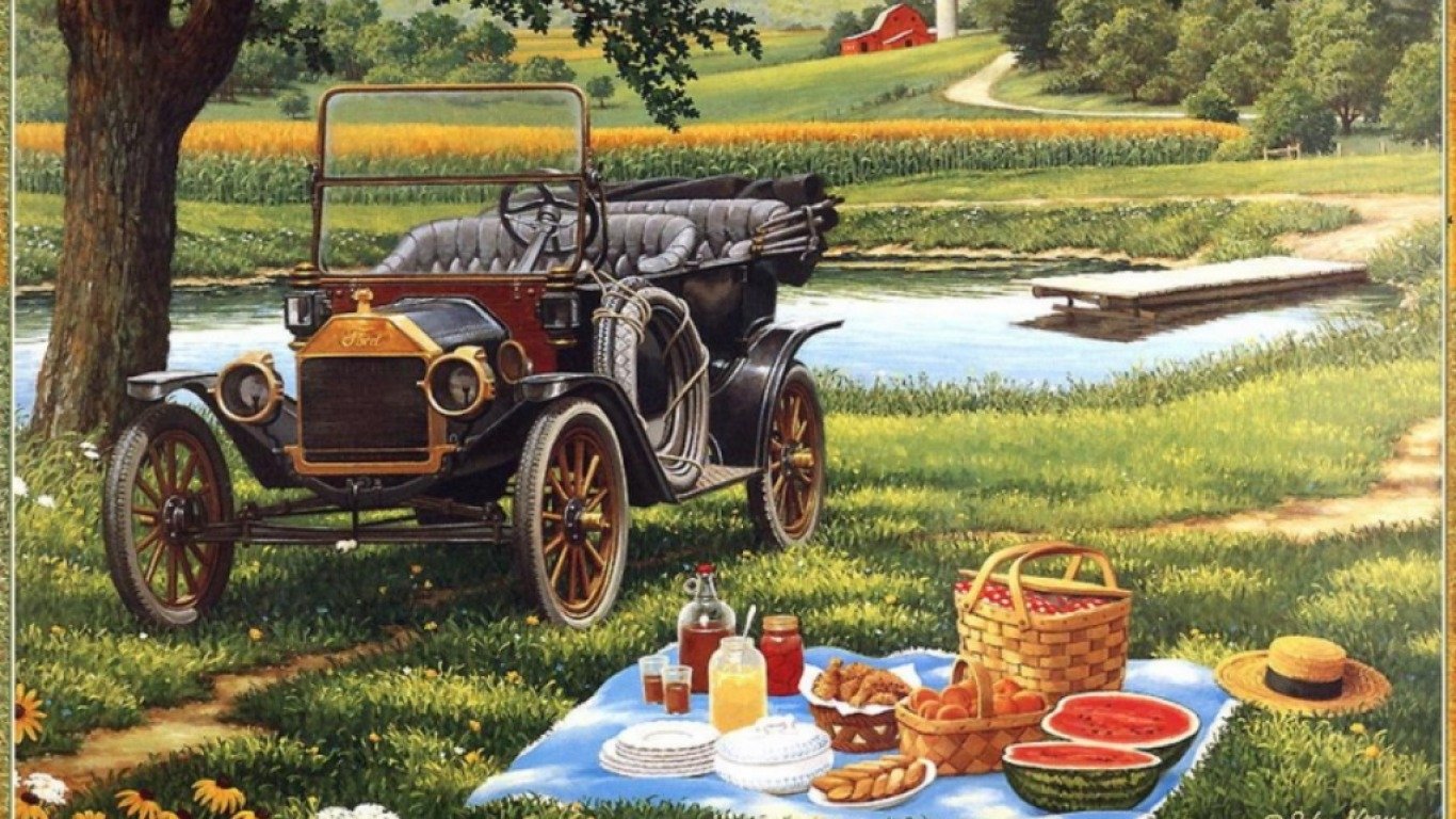 Artistic painting of a vintage car parked near a pond with a picnic setup on a blanket, featuring food, drinks, and a basket under the shade of a tree.
