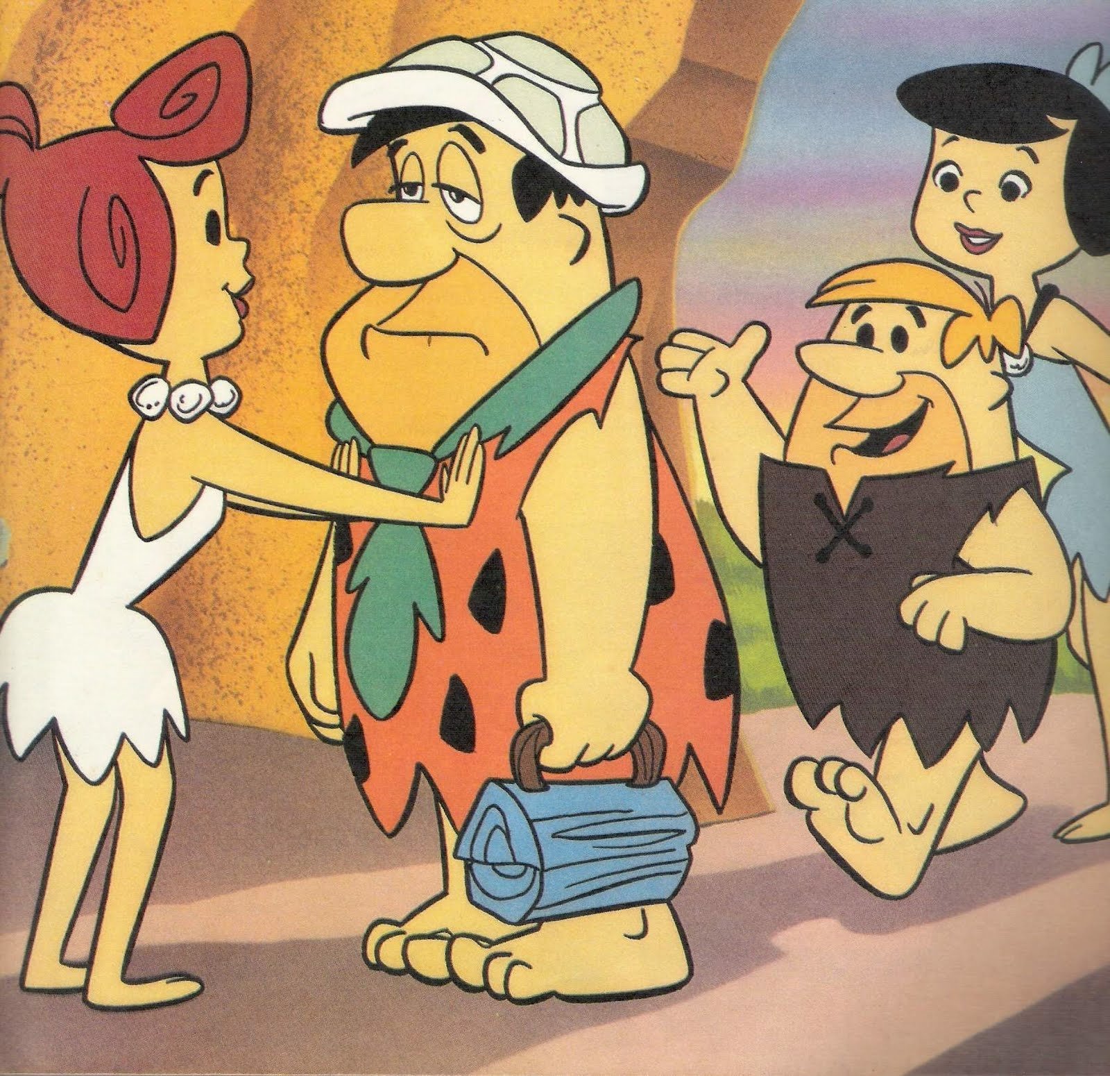 Scene from The Flintstones TV show featuring Betty, Fred, Barney, and Wilma Flintstone inside their stone-age home.