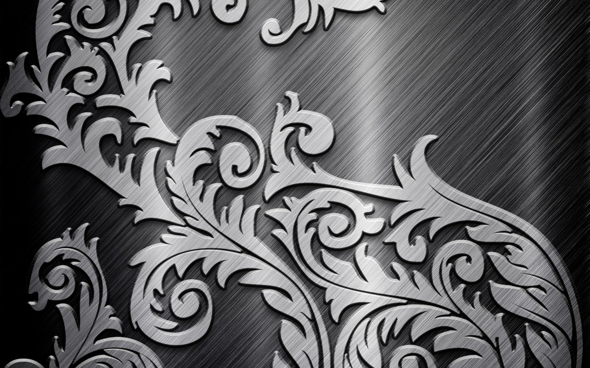 Abstract metal design featuring intricate, swirling floral patterns on a brushed dark metal background, showcasing detailed craftsmanship and modern elegance.