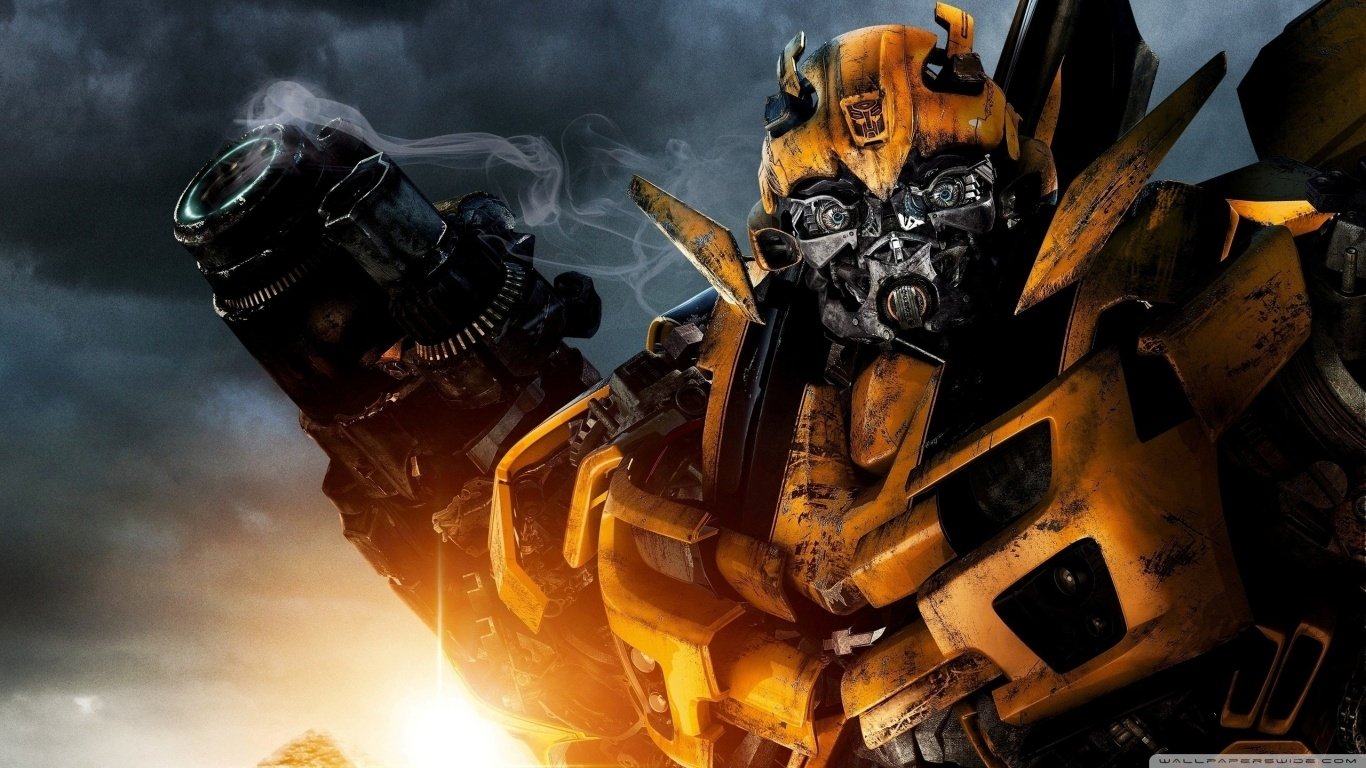 Close-up of Bumblebee, a yellow robot from the Transformers movie, with a cloudy sky and sunset in the background.