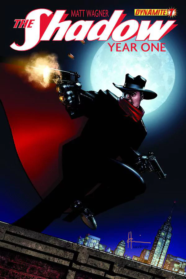 Comic cover — The Shadow: masked vigilante in wide-brim hat and red scarf leaps from a rooftop, firing twin pistols before a full moon over a city skyline.