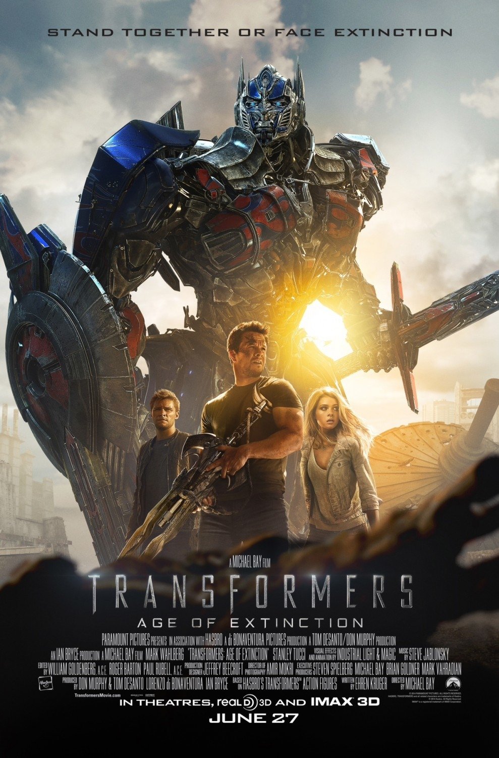Poster for the movie Transformers: Age of Extinction showing a large robot with three human characters standing in front, with the tagline Stand Together or Face Extinction.