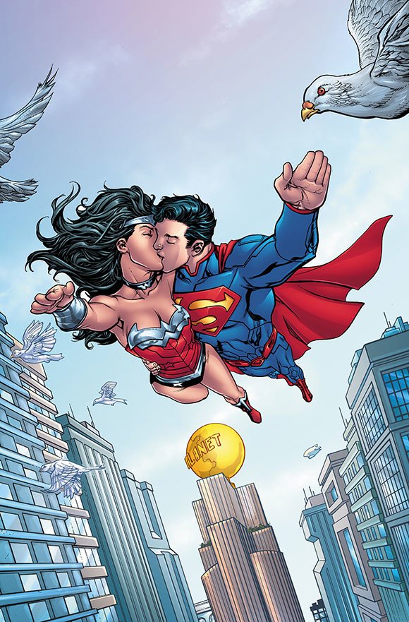 Superman and Wonder Woman share a kiss mid-flight above Metropolis, with the Daily Planet globe visible among city skyscrapers and doves flying around them.