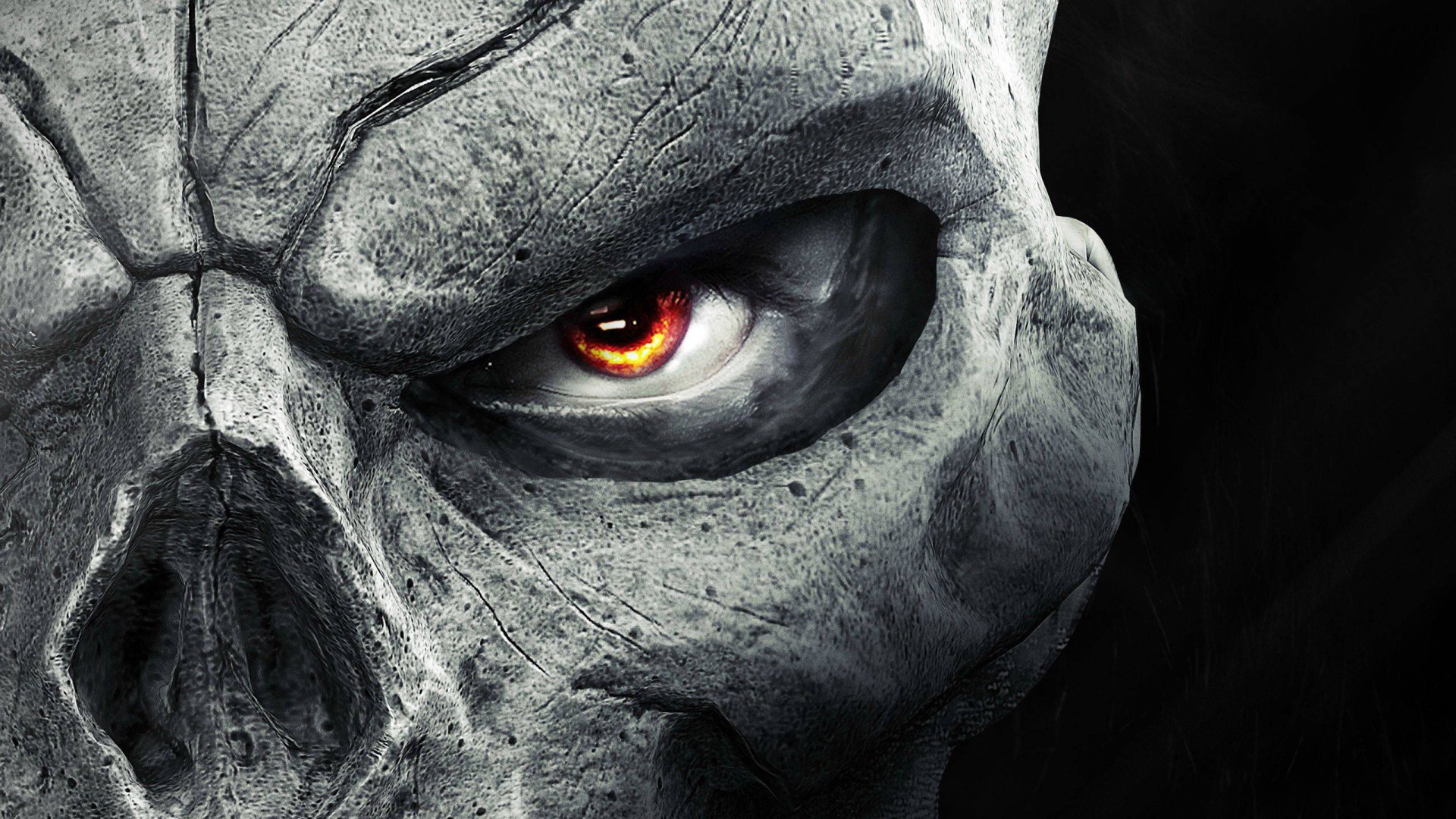 Close-up of a cracked skull with a glowing orange eye, representing the dark and intense atmosphere of the video game Darksiders II.