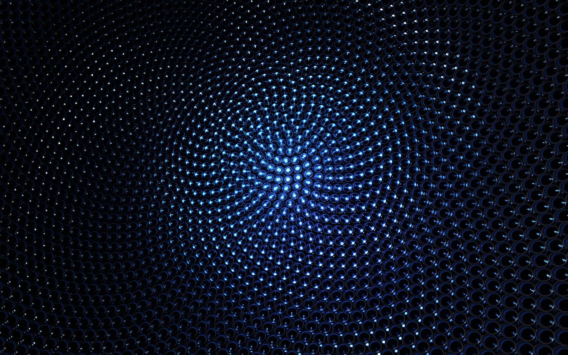 Abstract blue pattern featuring a spiral of glowing dots creating a dynamic, textured effect against a dark background.
