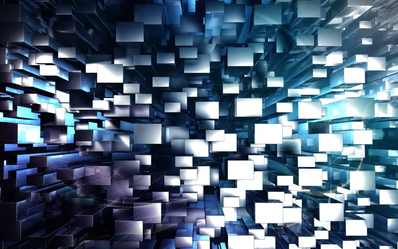 Abstract composition of numerous reflective cubes arranged in a dynamic, three-dimensional pattern with varying shades of blue and light reflections.