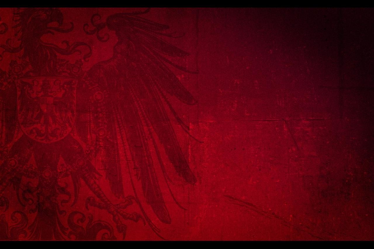 Abstract image featuring dark red tones with subtle patterns and textures blending into the background.