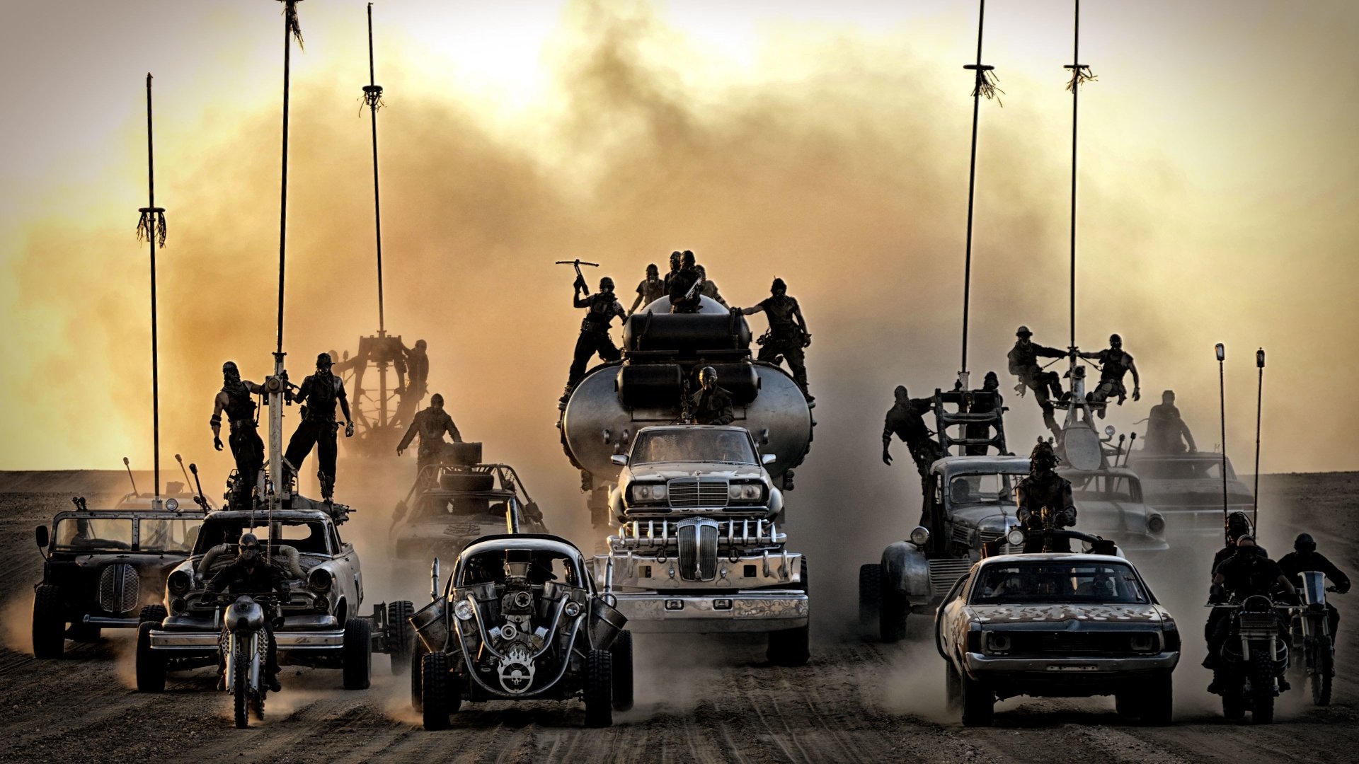 Mad Max: Fury Road convoy of armored war rigs and motorcycles racing across a desert, silhouetted riders atop vehicles, dust and smoke filling the sky.