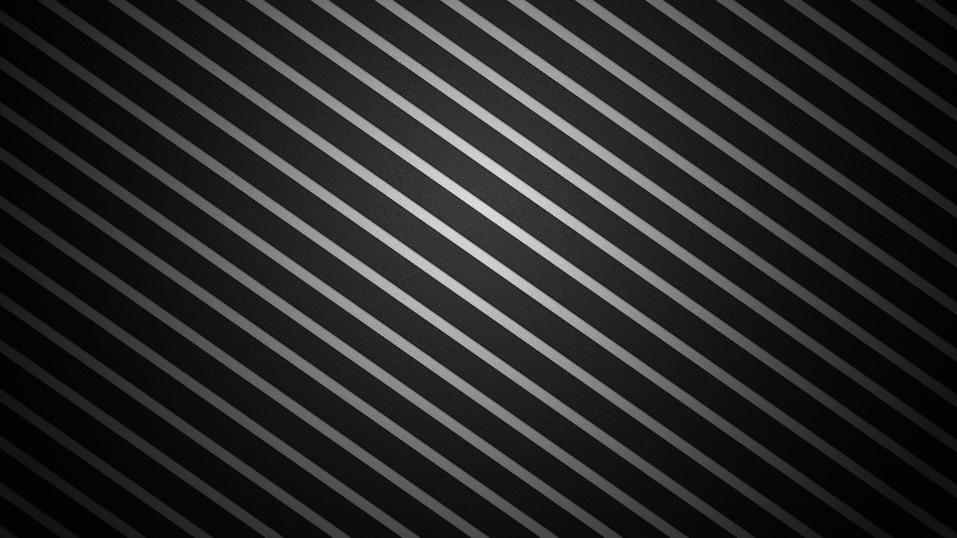 Artistic design of diagonal black and dark-gray metallic stripes with a subtle central sheen, forming a sleek, rhythmic textured pattern.