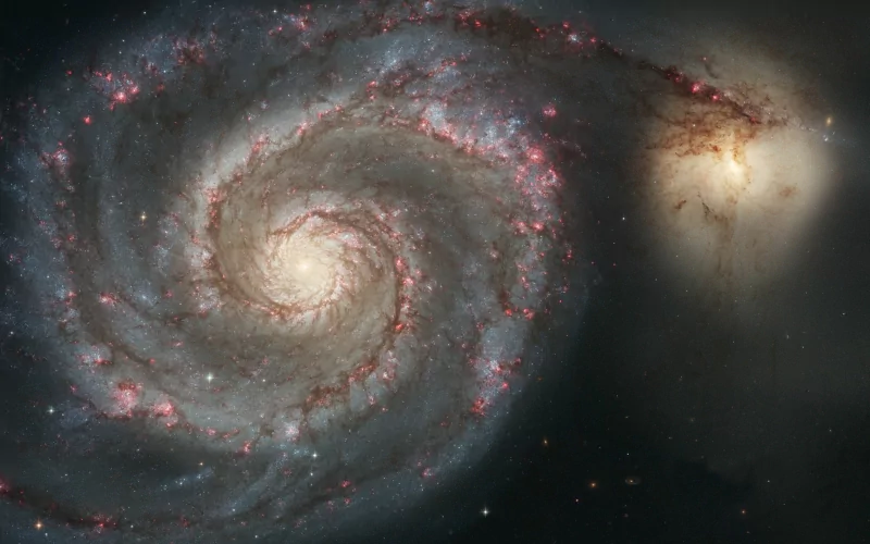 Spiral galaxy with glowing core and bright arms, set against a dark space background, evoking a vivid sci-fi cosmic scene.