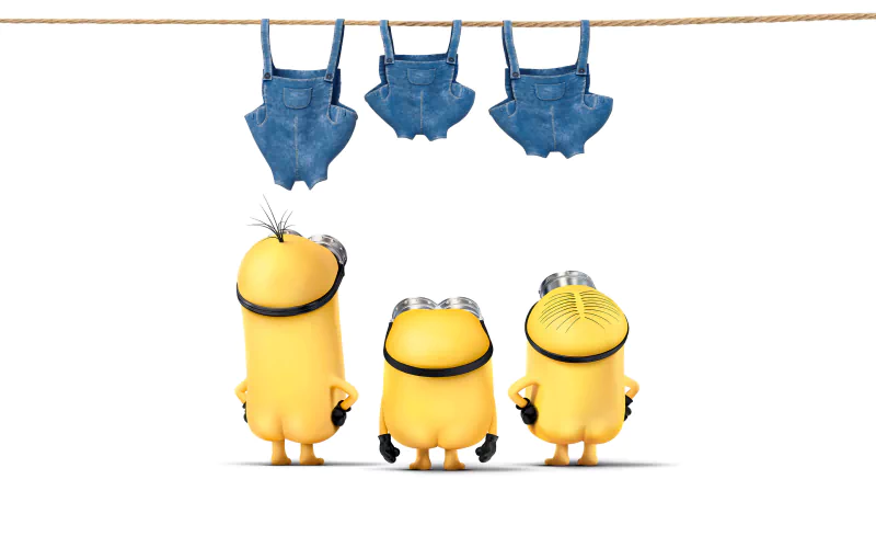 Three Minions from the movie Minions stand with their backs turned, looking up at three denim overalls hanging on a clothesline against a white background.