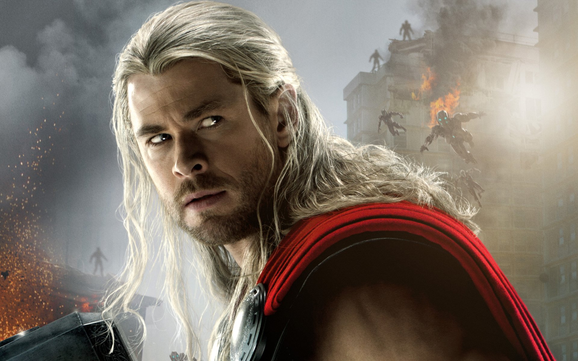 A striking image of Thor from the movie Avengers: Age of Ultron, featuring his long hair and iconic red cape against a backdrop of chaos and destruction.