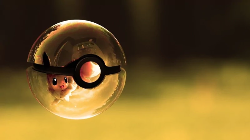 A close-up of a Poké Ball containing an adorable Pokémon, set against a soft, blurred background. The image captures the vibrant essence of anime and the Pokémon universe.