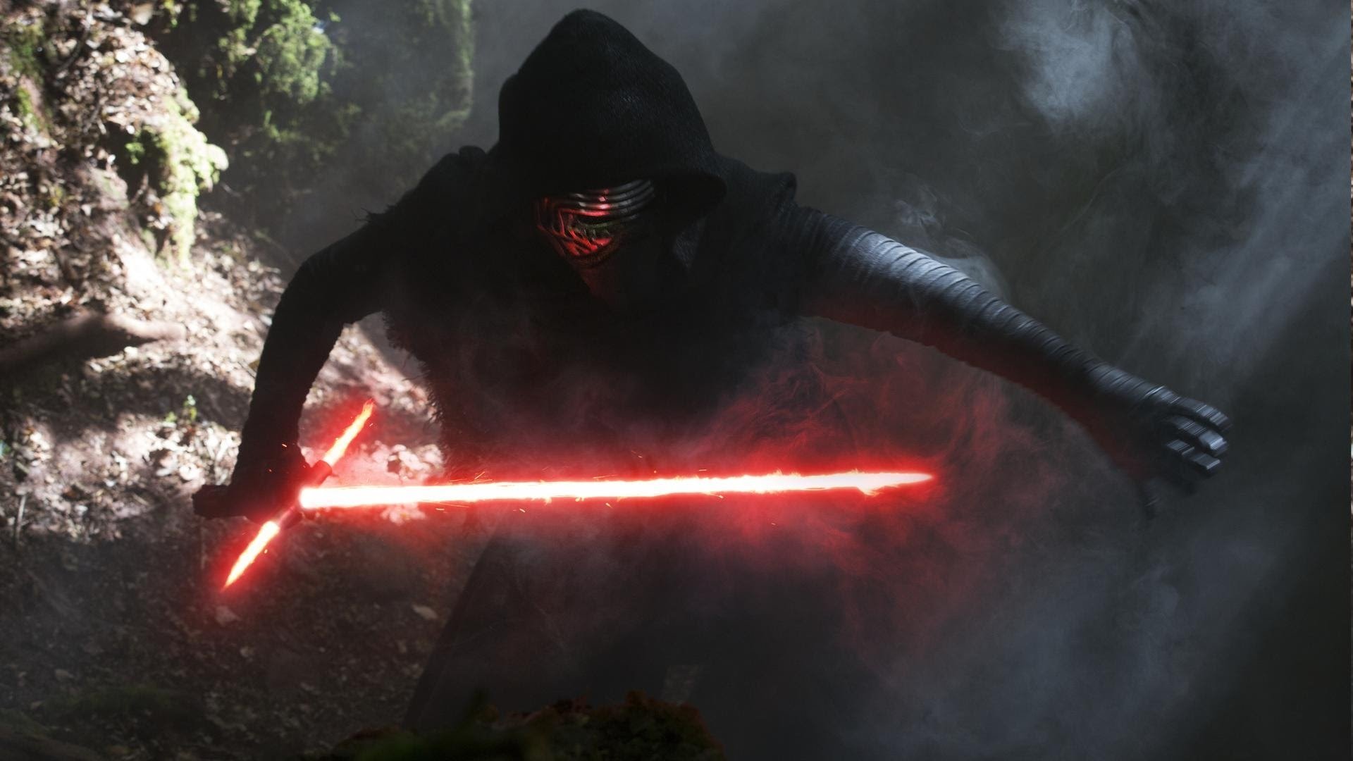Kylo Ren from Star Wars Episode VII: The Force Awakens lunges through a misty forest, hooded and masked, igniting his crossguard red lightsaber.