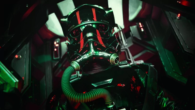 Close-up of a masked First Order TIE fighter pilot in a red-green lit cockpit, from the movie Star Wars Episode VII: The Force Awakens.