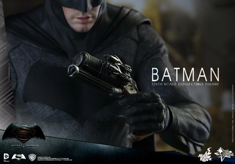 Close-up of Batman in tactical suit holding a gadget, from the movie Batman V Superman: Dawn Of Justice, showcased as a 1/6th scale collectible figure.