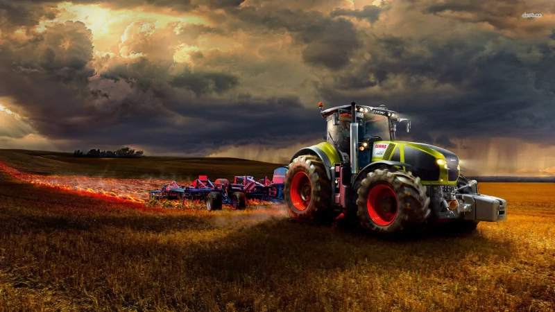 A Claas tractor works a golden field under a dramatic sky, leaving behind a trail as it plows through the earth, showcasing the blend of machinery and agriculture.