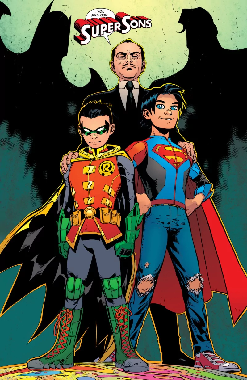 Jon Kent as Superboy and Damian Wayne as Robin stand confidently with Alfred Pennyworth behind them, featuring Batman's silhouette, in this dynamic DC Comics scene.